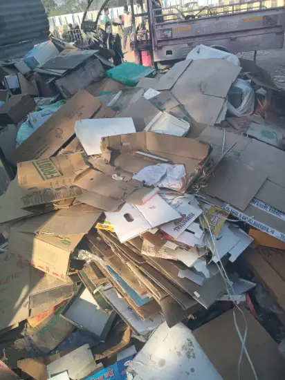 Cardboard and waste paper beside a pickup
