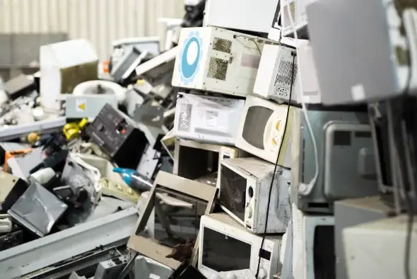 Old microwaves stacked for scrap